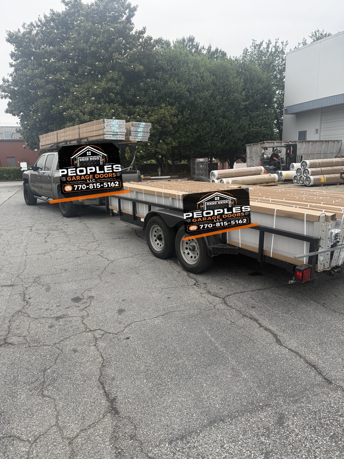 People's Garage Doors wrapped truck and trailer with long garage door packages loaded lengthwise